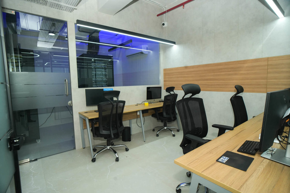IT Cabin along with a view of a technician looking into a server room cabin